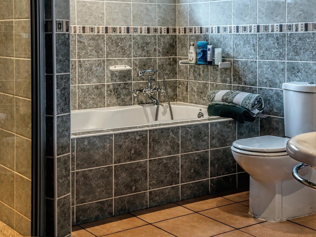 Remodeled bathroom with a tiled tub surround