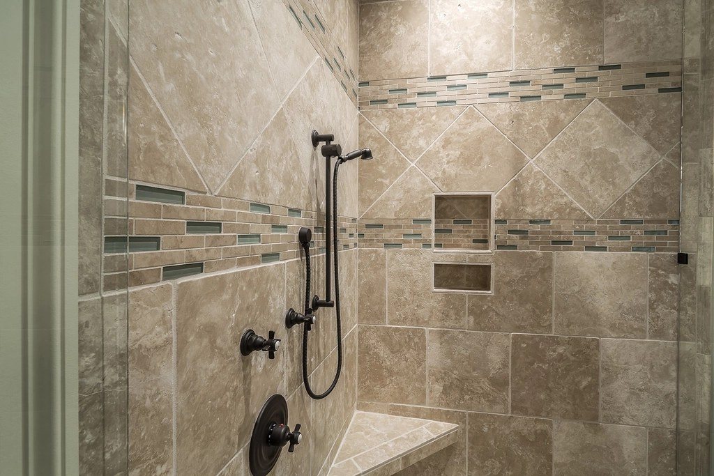 Tiled walk-in shower with a built-in niche